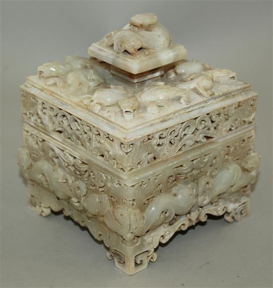 A Chinese archaistic burnt white and russet jade seal box and cover, width 12cm, height 14cm, wood stand